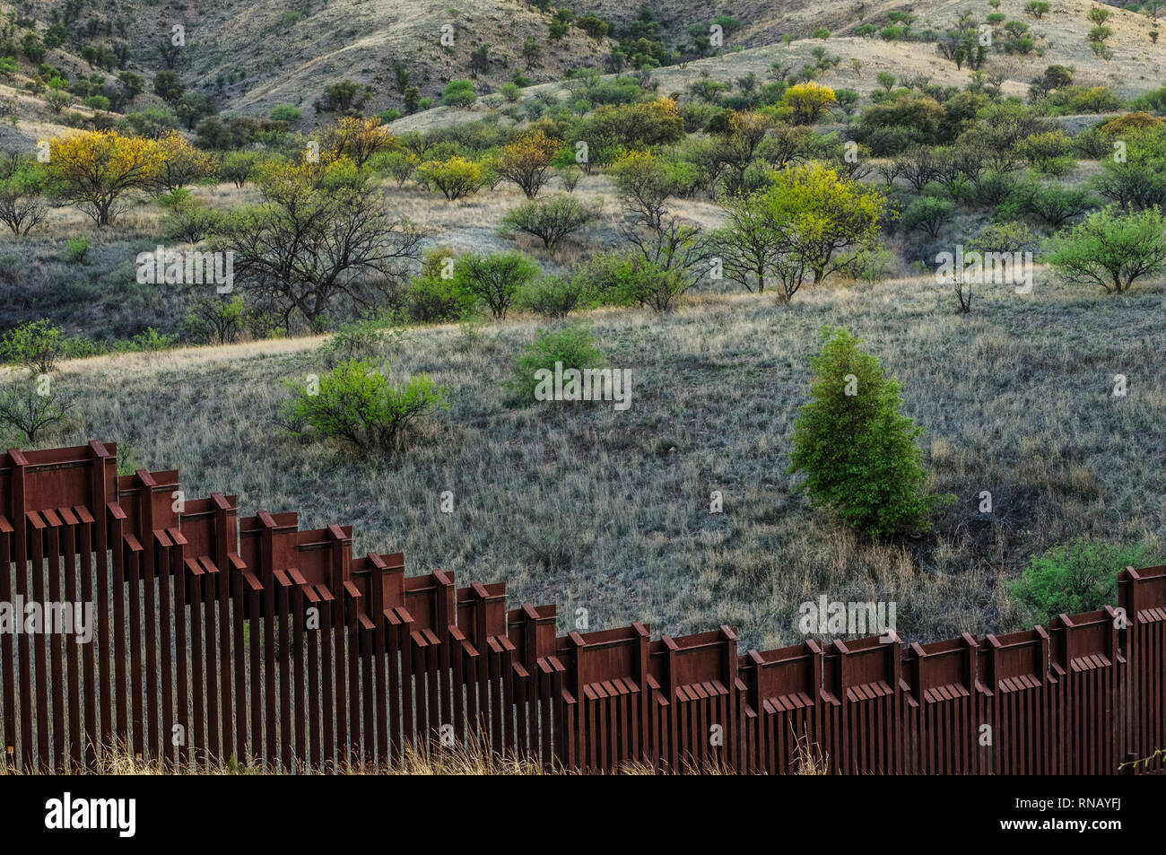 Looking over US border fence into hilly Mexico, bollard style pedestrian barrier, viewed from US side, east of Nogales Arizona, April 2018 Stock Photo