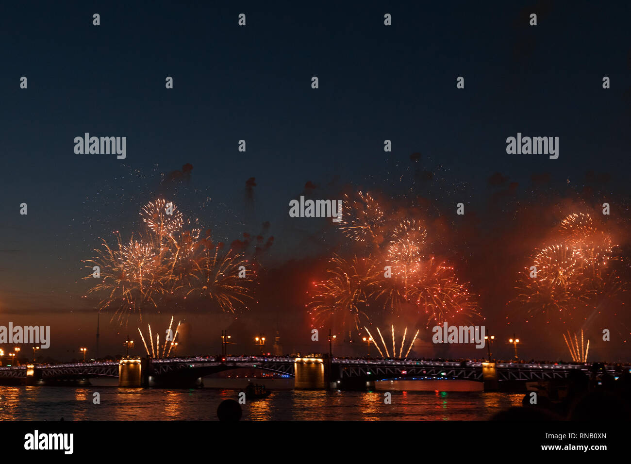 Colorful fireworks reflect from water, beautiful bridge scenery Stock ...