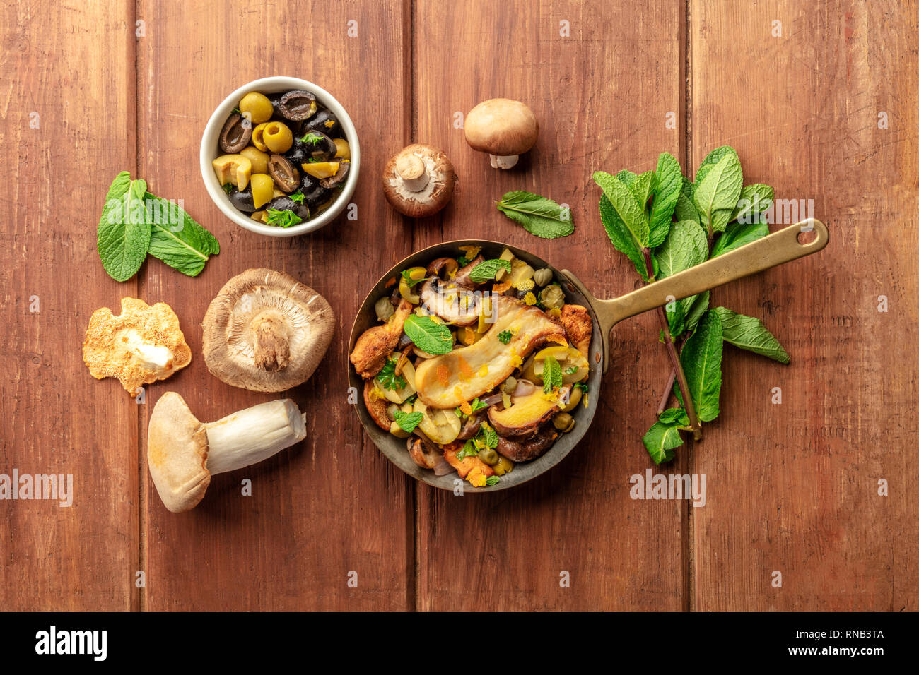 A rustic mushrooms and olives saute with mint, shot from the top with ...