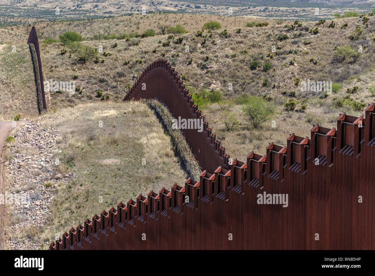 US border fence on Mexico boundary, bollard style pedestrian barrier, viewed from US side, remote hilly terrain, east of Nogales Arizona, April 2018 Stock Photo