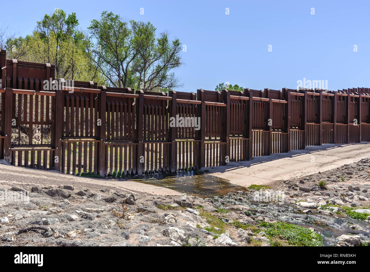 US border fence on Mexico boundary, bollard type pedestrian barrier, special design to allow water flow, US side, east of Nogales Arizona, April 2018 Stock Photo