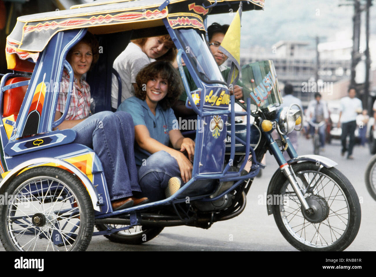 1982 - Philippines - Dependent wives of crewmen from the guided missile cruiser USS STERETT (CG-31) ride in a jeepney, a form of local transportation. Stock Photo