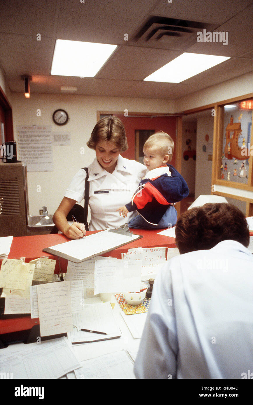 An Air Force nurse checks her child in at the Kitty Hawk child-care center. Stock Photo