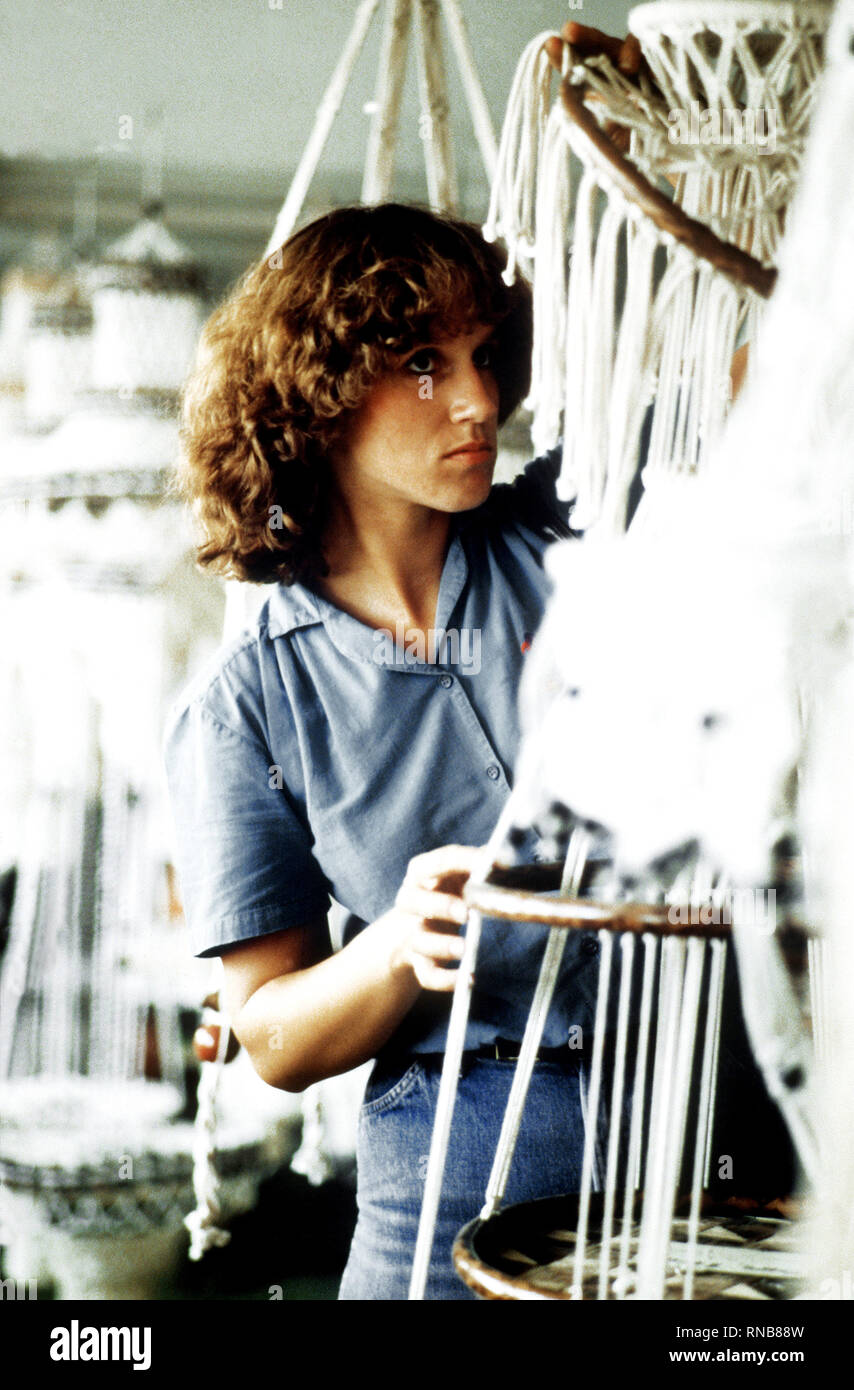 1982 Philippines - A dependent wife of a crewman from the guided missile cruiser USS STERETT (CG-31) considers the purchase of a macrame plant hanger. Stock Photo