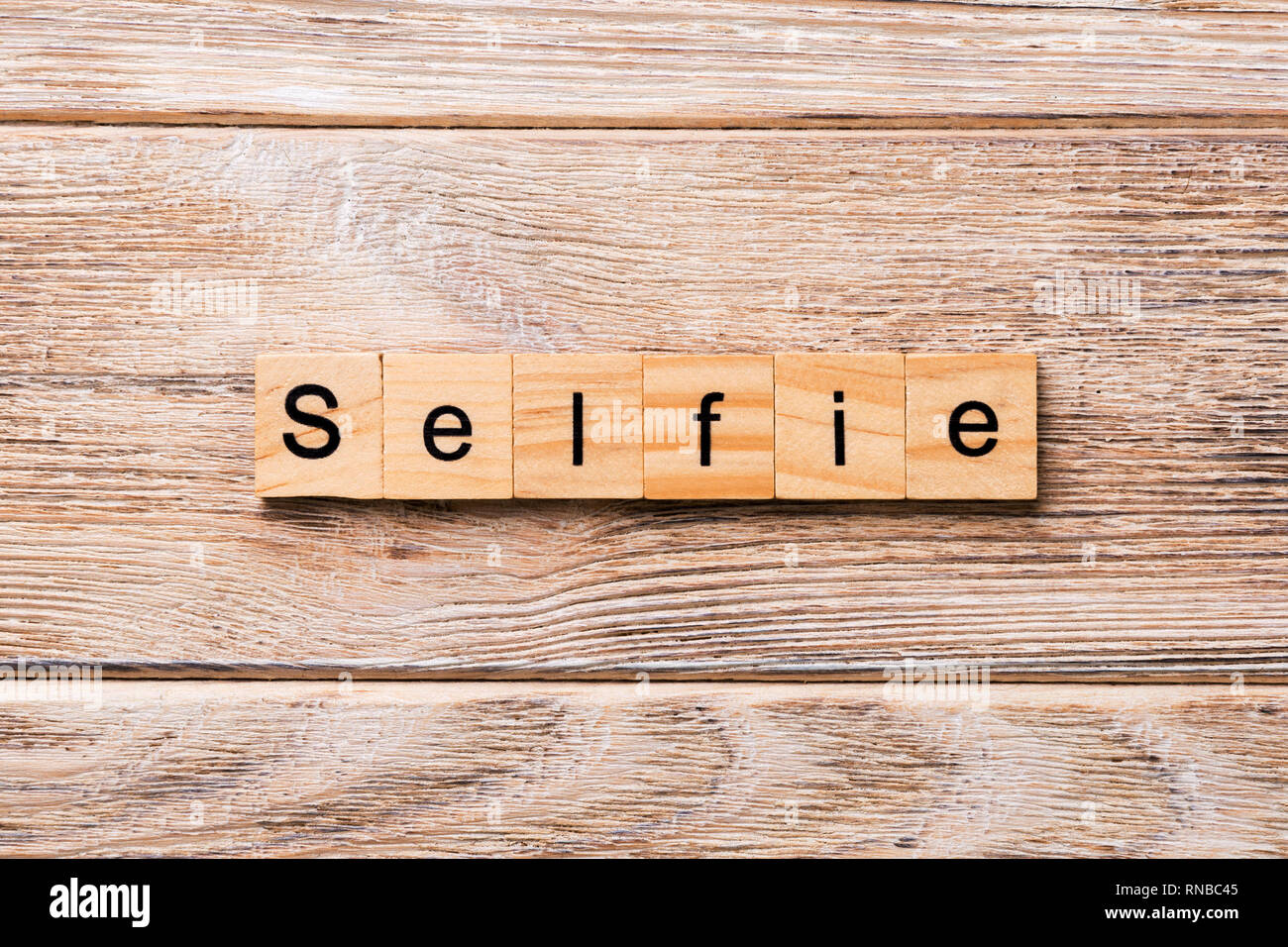 selfie word written on wood block. selfie text on wooden table for your