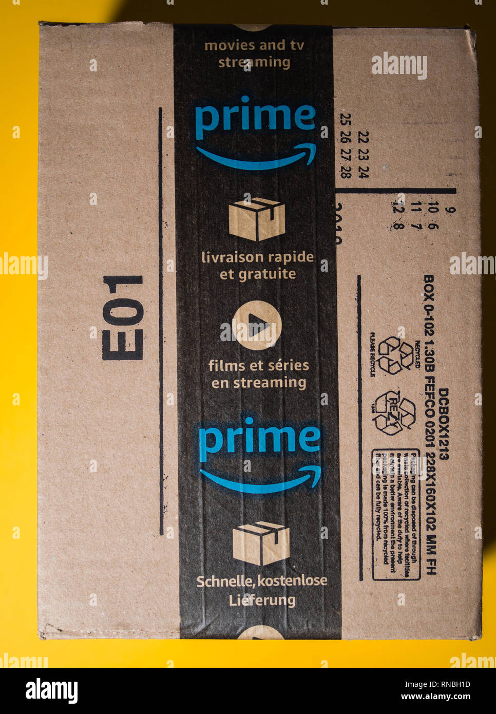 PARIS, FRANCE SEP 28, 2018 New Amazon Cardboard box against yellow