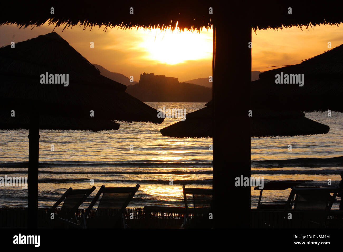 A sunset on the beach with Procida island view Stock Photo