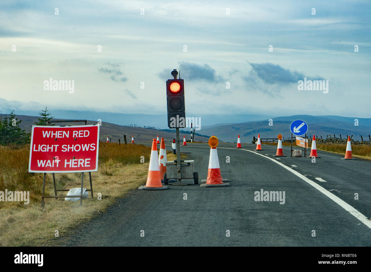 temporary traffic lights on a rural road Stock Photo