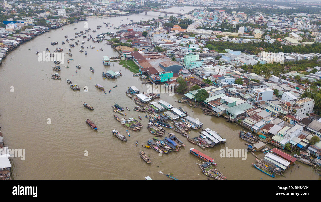 Aerial view, top view Cai Rang floating market. Tourists, people buy and sell food, vegetable, fruits on boat, ship at river market Stock Photo