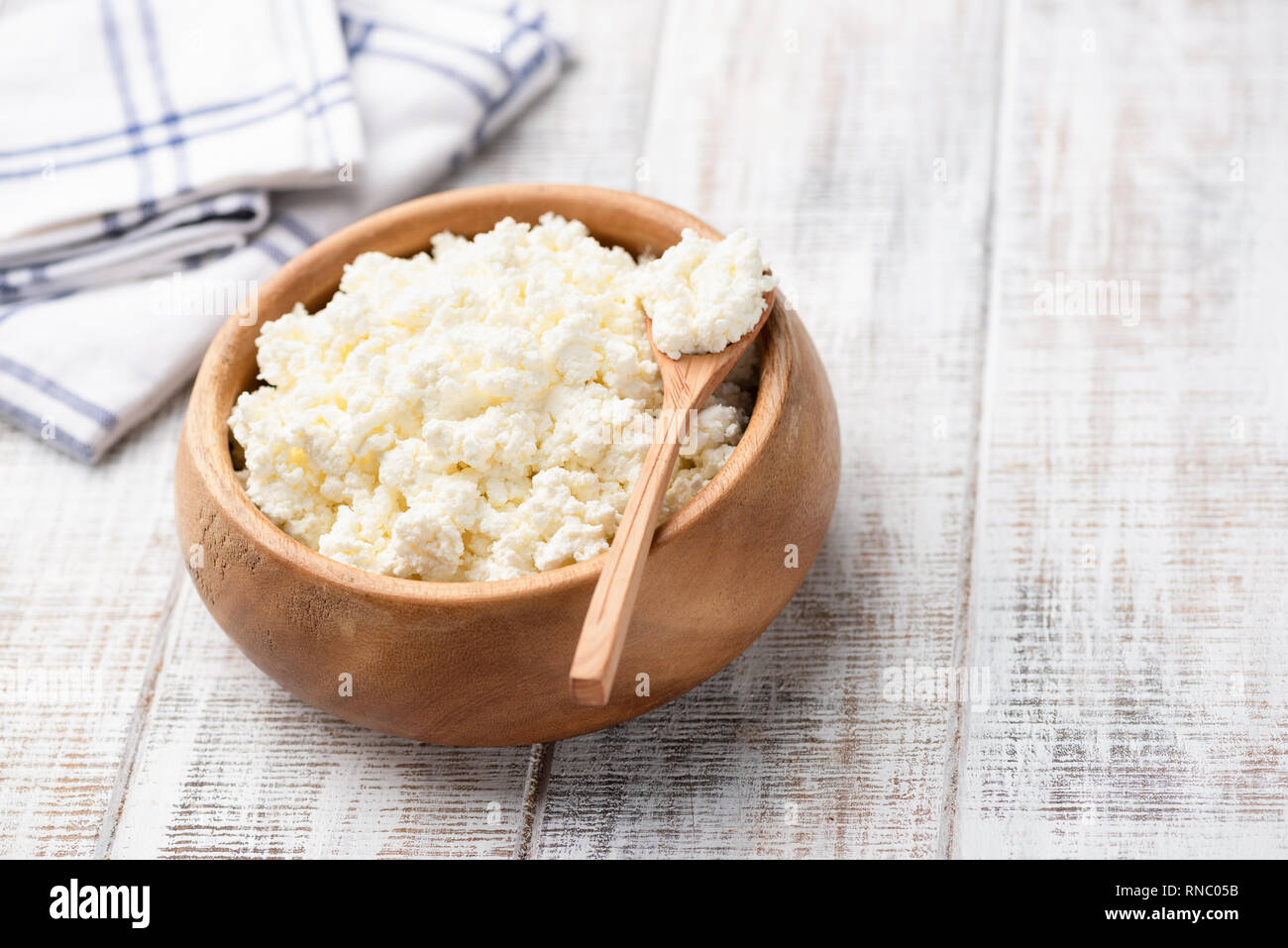 Cottage Cheese Tvorog Or Farmers Cheese In Wooden Bowl On White