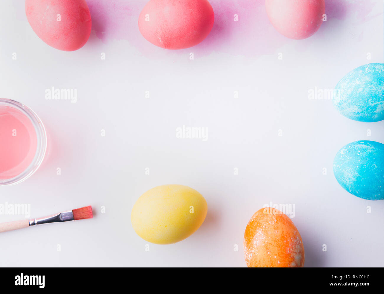 Painted eggs flat lay on a white background. Easter and spring ...