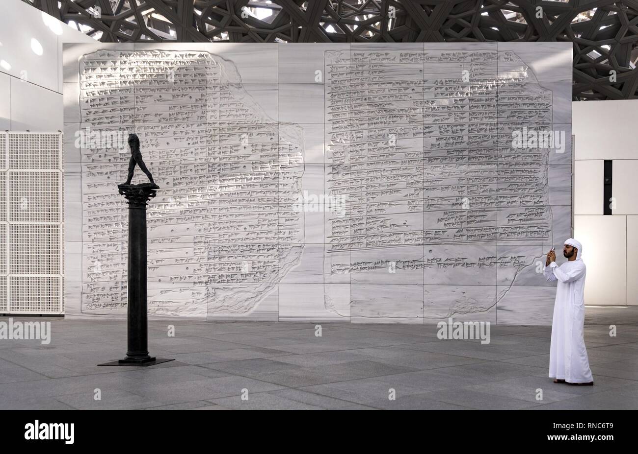 An Arab visitor photographs in the Louvre Abu Dhabi