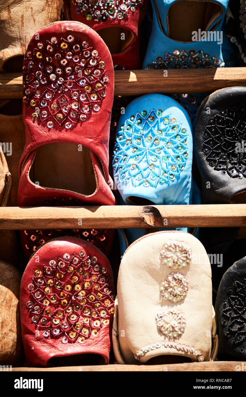 Colourful leather slippers known as babouches, in the market place of a souk in Marrakech, Morocco Stock Photo