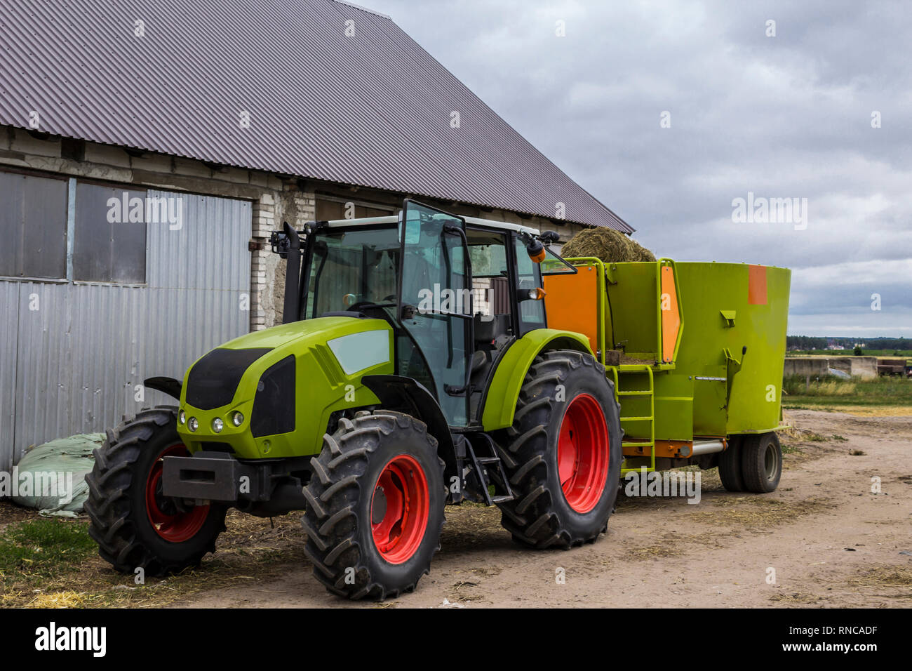 Tractor with a trailer for mixing and distribution of feed for cows