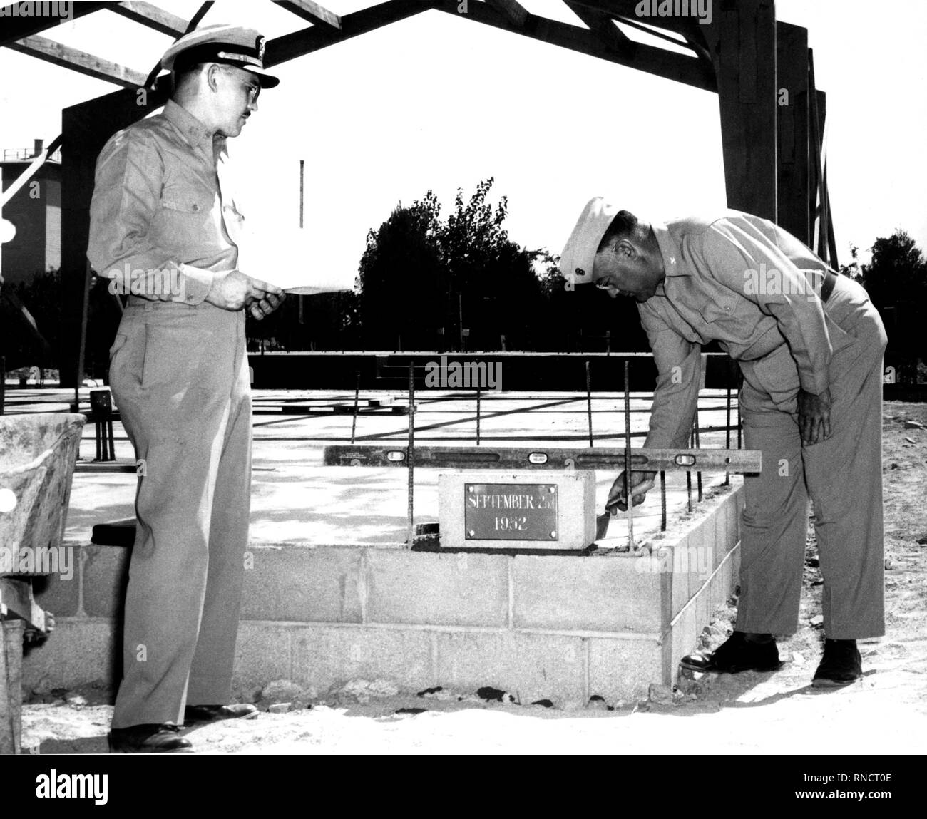 Cornerstone laying ceremony of the new Depot Chapel at the Barstow Annex of the Marine Corps Depot of Supplies, San Francisco, on 2 September 1952.  The service was conducted by US Navy Chaplain Warren L. Bost (Left), Protestant Chaplain at the Barstow Annex, with US Marine Colonel Arthur J. Davis, Commanding Officer of the Barstow Annex setting the cornerstone in place. Stock Photo