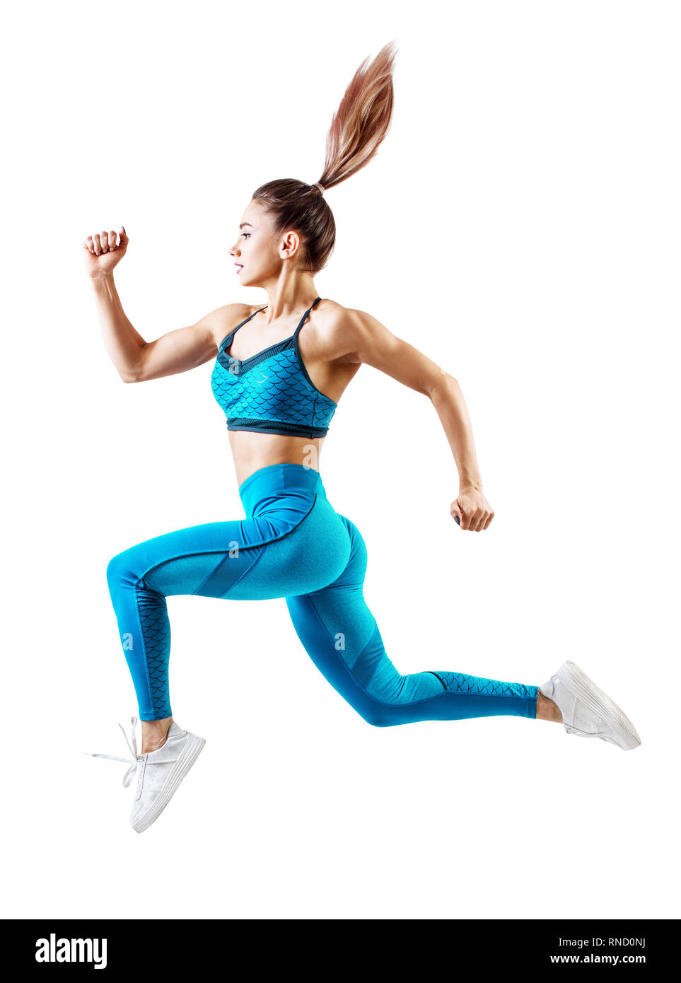 Young woman runner in blue sportswear jump in the air. Stock Photo