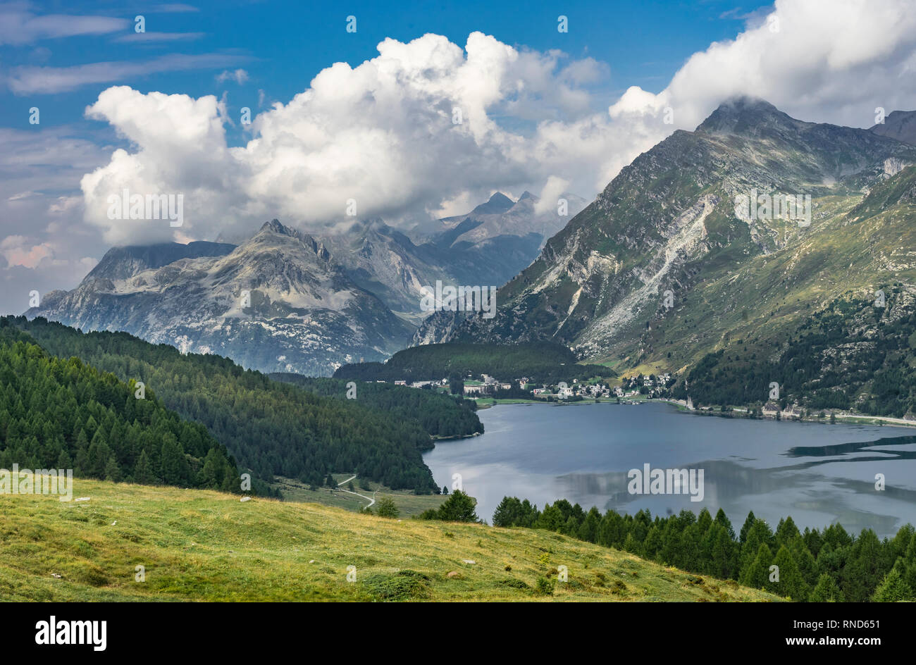 Senior woman, riding here e-mountain bike on the famous trails around the lakes in the upper Engadin, between Saint Moritz and Maloja, Switzerland Stock Photo