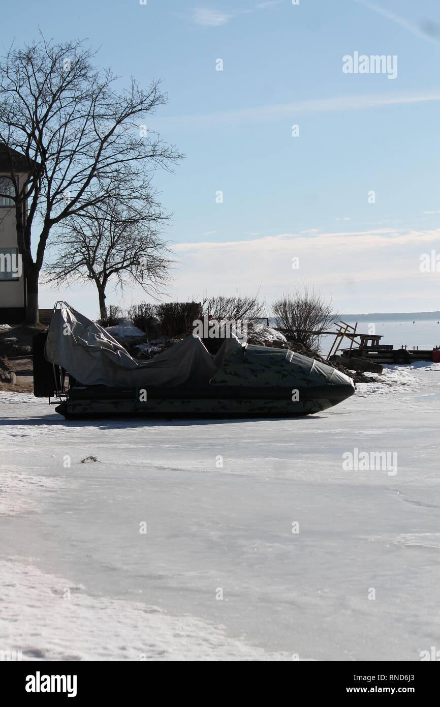 sport boat stay on ice prepare to race on frozen surafce of sea Stock Photo