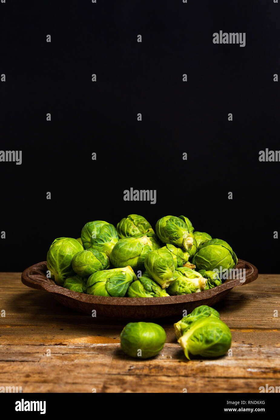 Brussels sprout vegetables in a bowl on a table Stock Photo