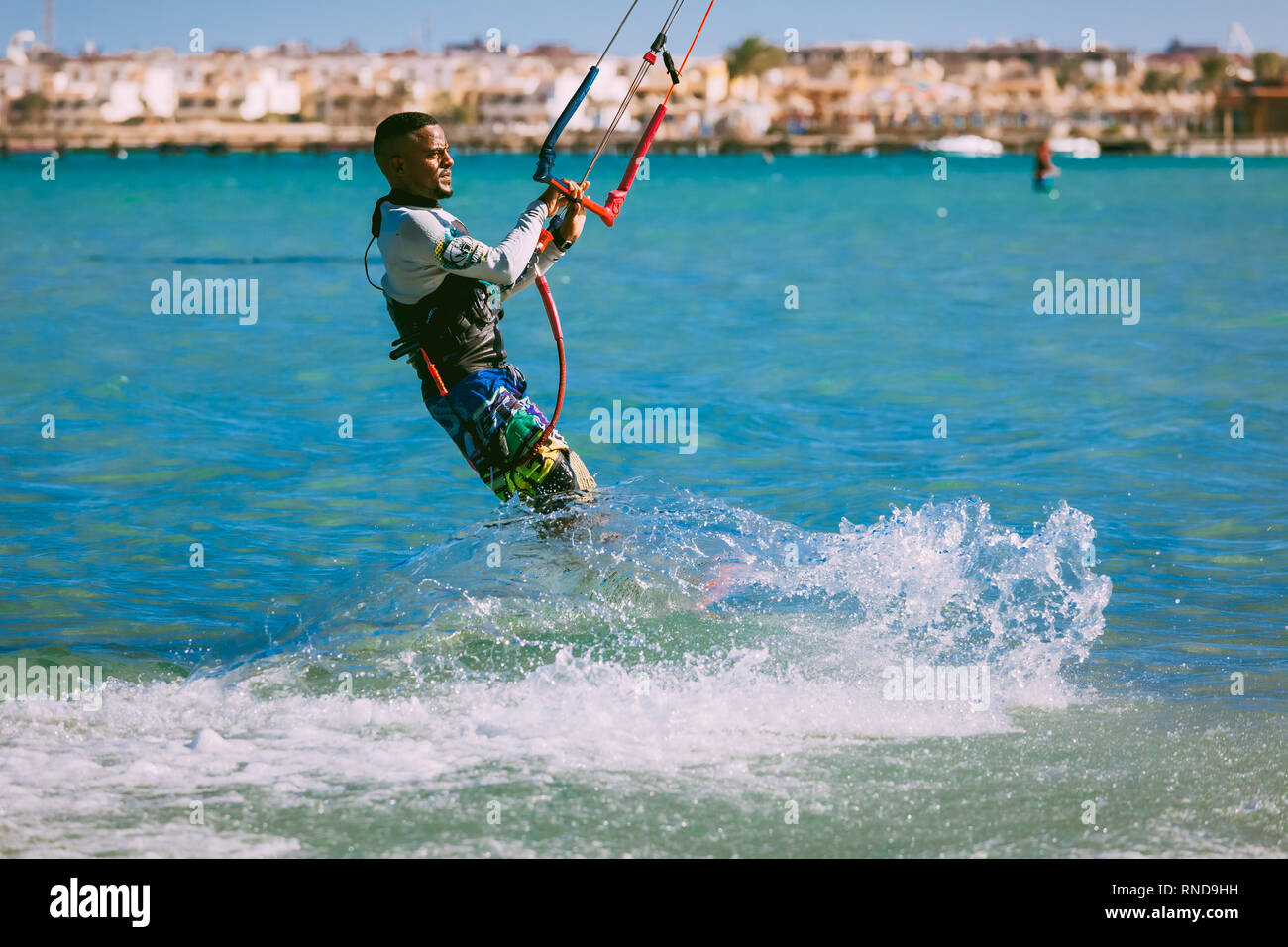 Egypt, Hurghada - 30 November, 2017:The kitesurfer gliding on the Red sea waves. The outdoor water sport activity. Popular tourist attraction. The Pan Stock Photo