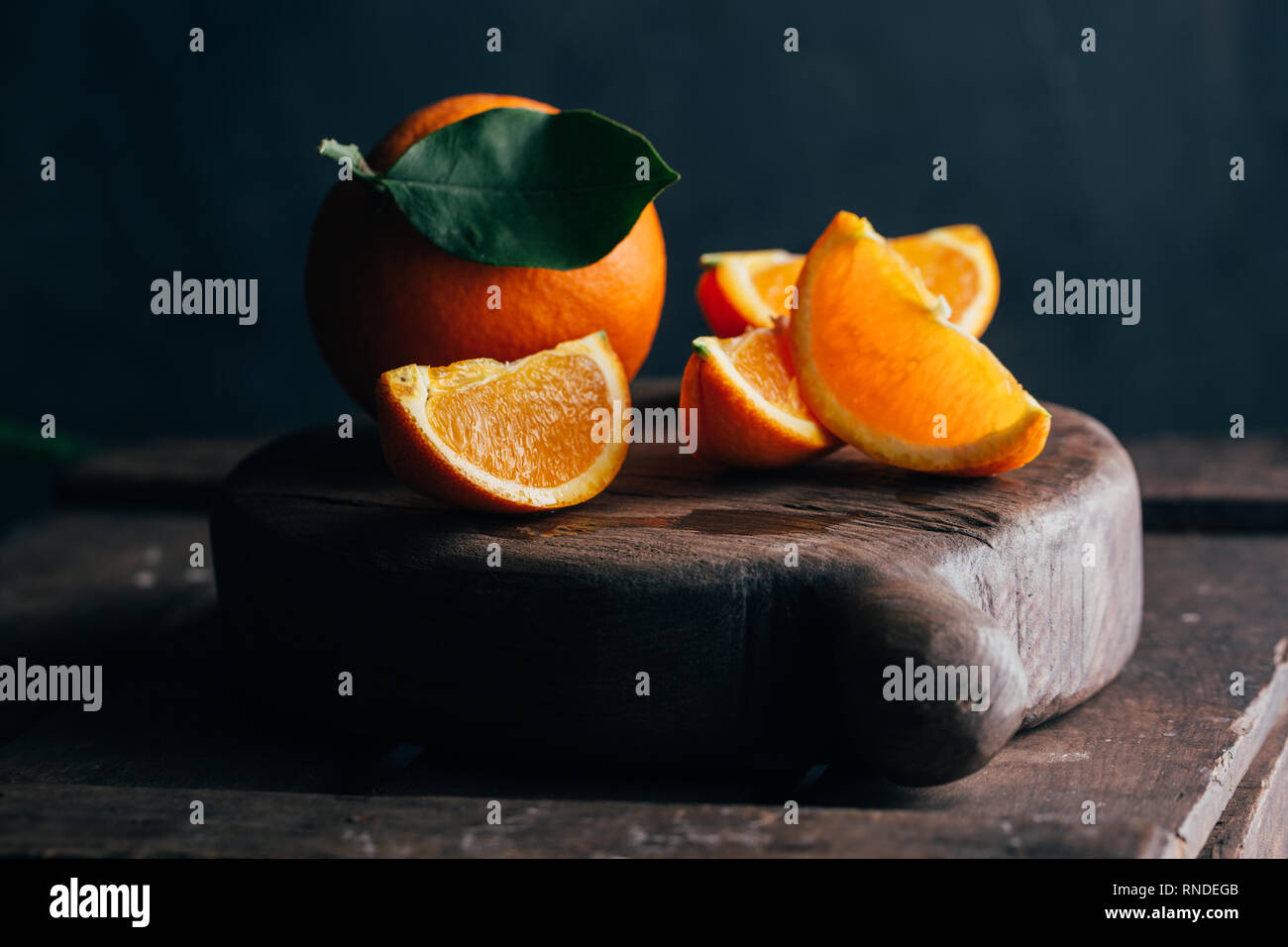 Fresh cut oranges on dark moody background Stock Photo
