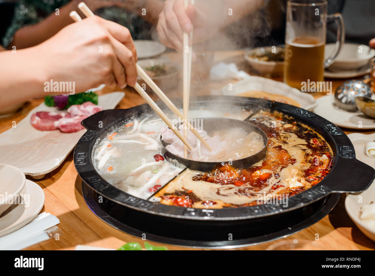 Family eating a hot pot Stock Photo Alamy