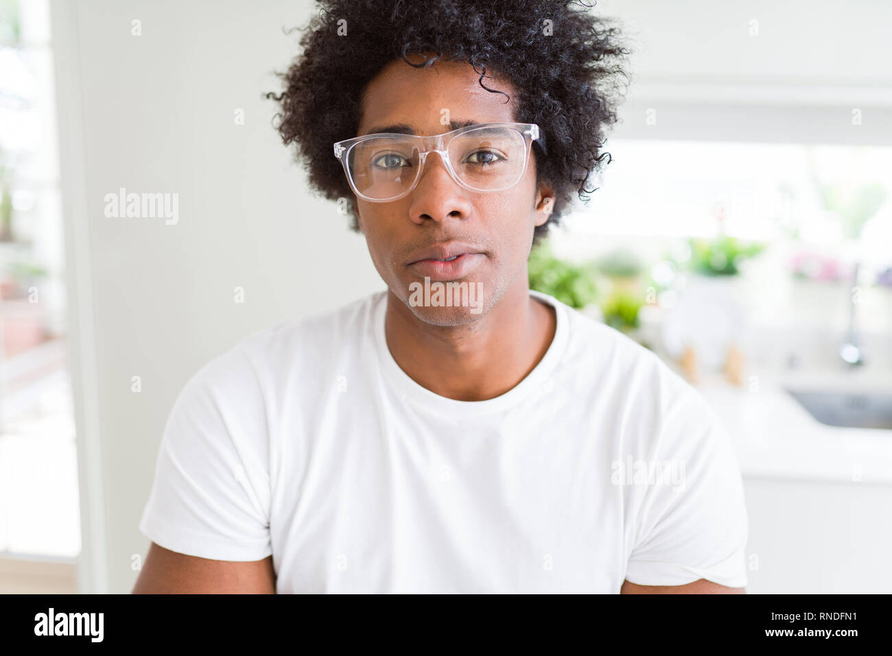 African American Man Wearing Glasses Relaxed With Serious
