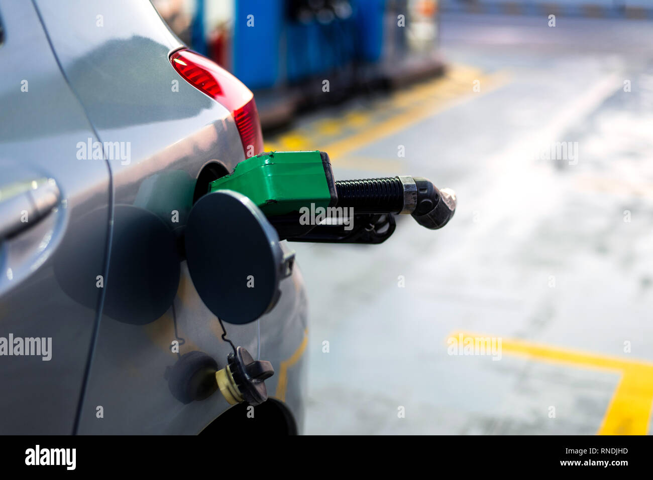 Nozzle in the car for adding petrol close up Stock Photo