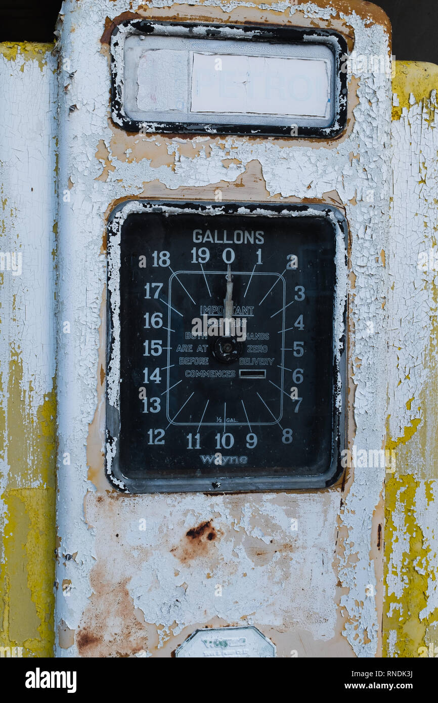 Close up of a rusty old single yellow petrol pump, with a large dial showing gallons Stock Photo