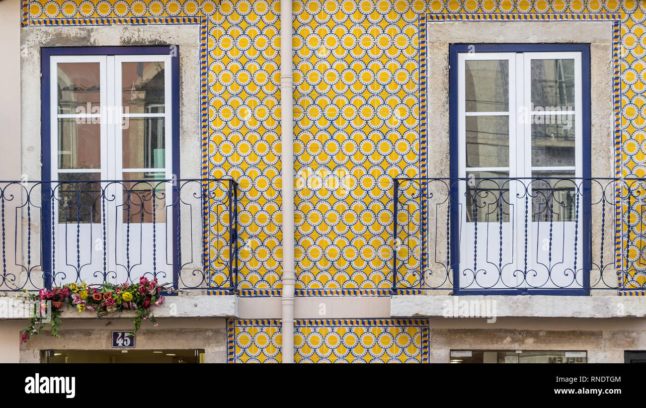 Flowerpots and house plants on an old weatherd balcony in Lisbon, Portugal Stock Photo