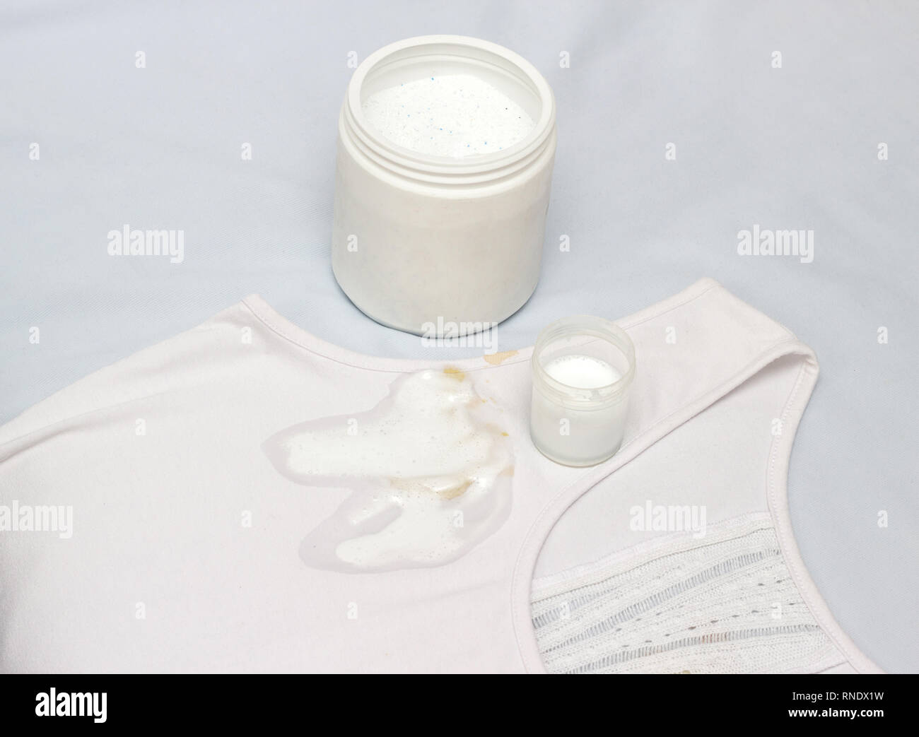 Spot on a white Tshirt filled with stain remover, fighting stains on