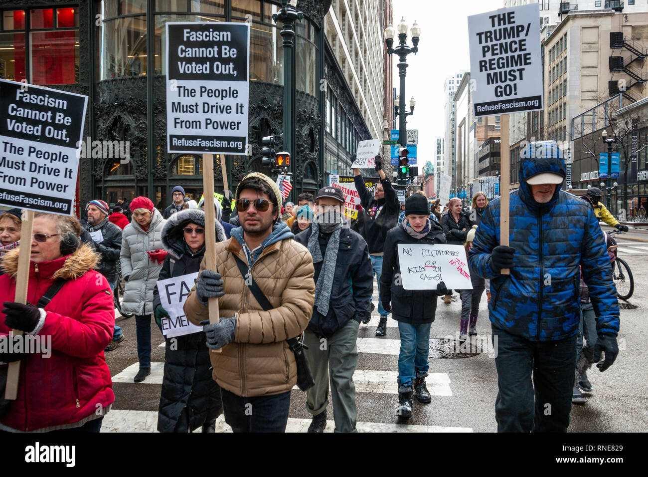 Chicago, USA. 18th Feb 2019. Concerned Chicagoans gathered at noon on President's Day 2019 at Federal Plaza in Chicago to protest President Trump's declaration of a national emergency at the border in order to fund his border wall project. After listening to speeches by Illinois Congressman Chuy Garcia and others, the demonstrators marched on Adams street and then north on State Street to take their protest to Trump Tower. Credit: Matthew Kaplan/Alamy Live News Stock Photo