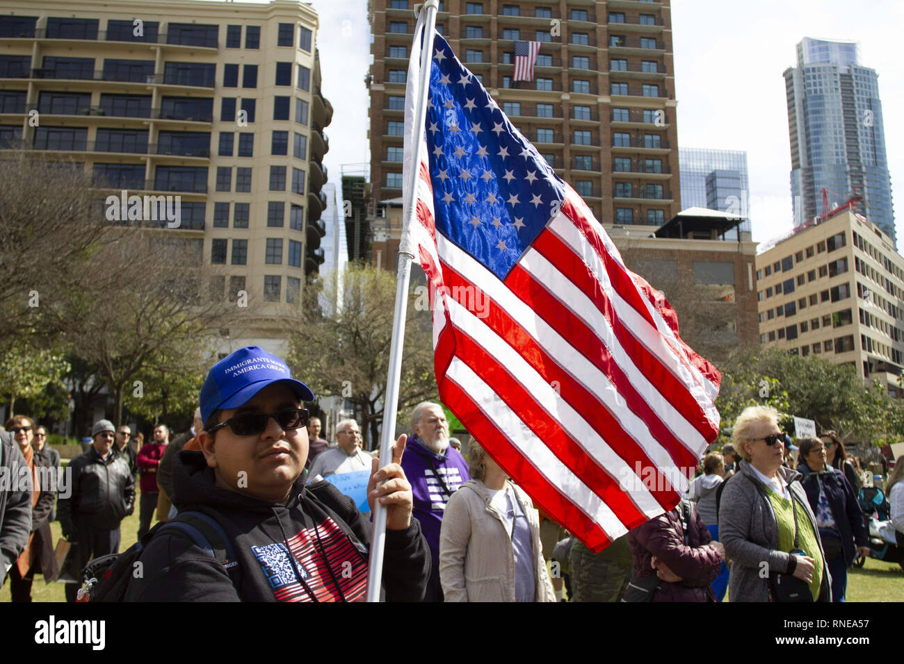 Austin, Texas, USA. 18th Feb, 2019. A man holds an American flag to call attention to President Trump's deciding to call for a National Emergency to force Congress to fund the building of a wall along the border between The United States and Mexico to keep immigrants from reaching the US during a protest at Republic Square Park in Austin Texas on President's Day. Credit: Jaime Carrero/ZUMA Wire/Alamy Live News Stock Photo