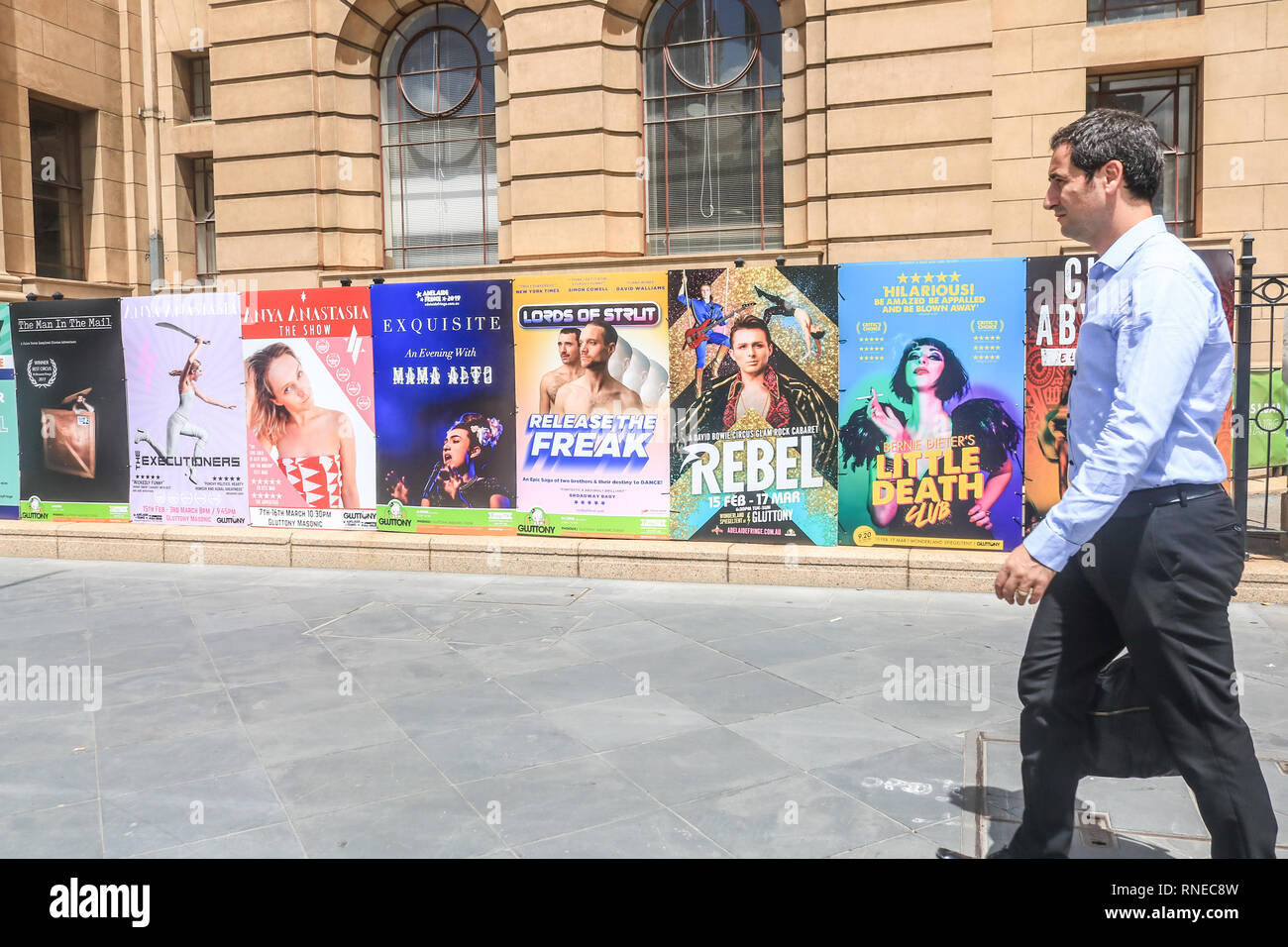 Adelaide Australia. 19th February 2019. A pedestrian walks past posters promoting  finge acts at the 2019 Adelaide Fringe festival. The Adelaide Fringe is the world's second-largest annual arts festival and runs from 15th February to 17 March Credit: amer ghazzal/Alamy Live News Stock Photo