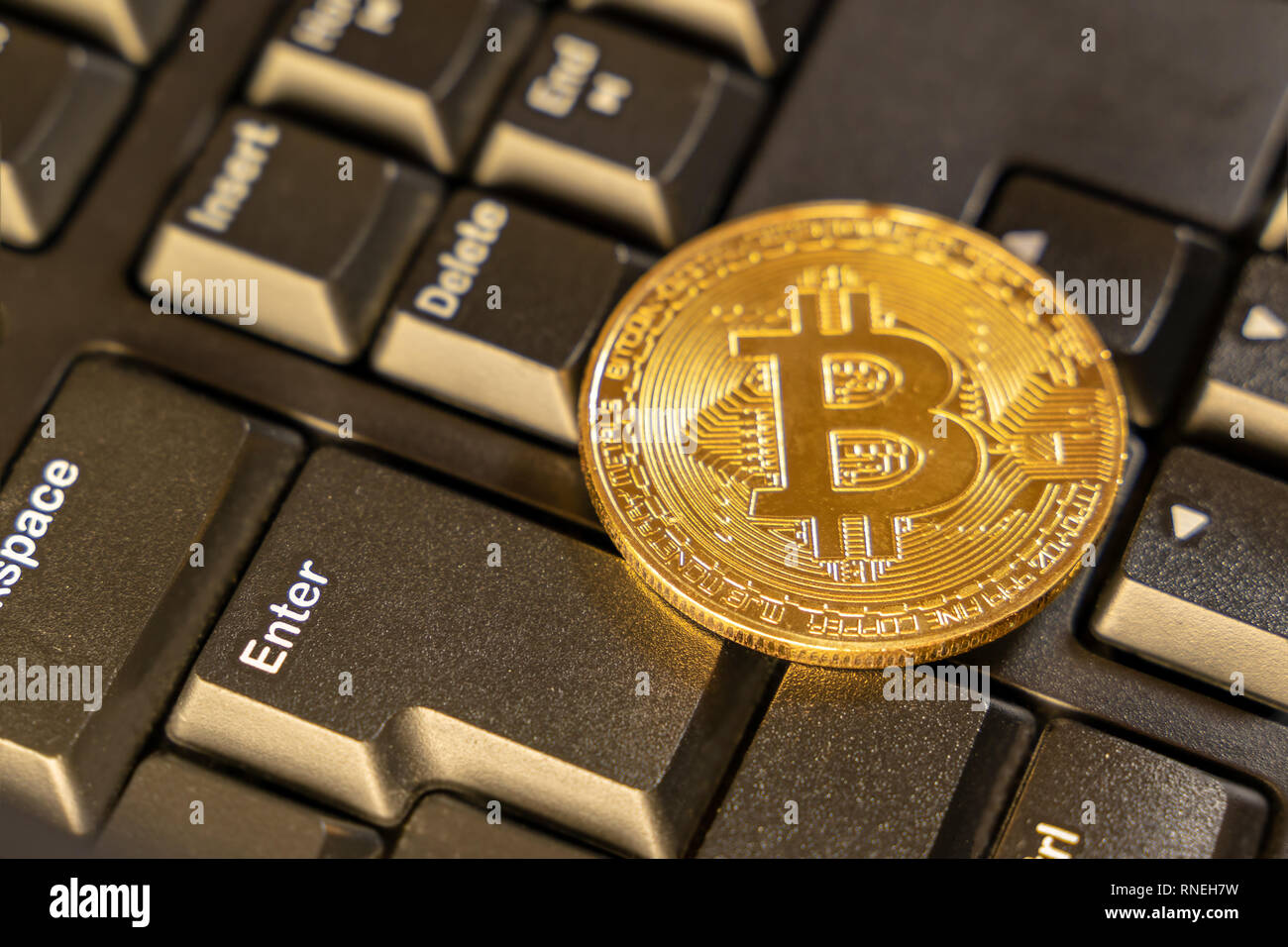 Close up bitcoin on top of computer keyboard at background, cryptocurrency accepting for payment and finance concept Stock Photo