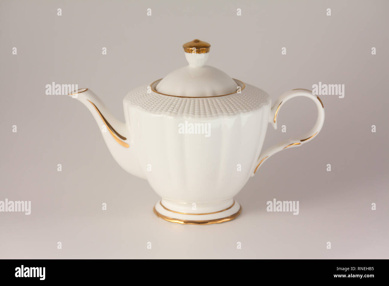Beautiful white porcelain teapot on white background Stock Photo