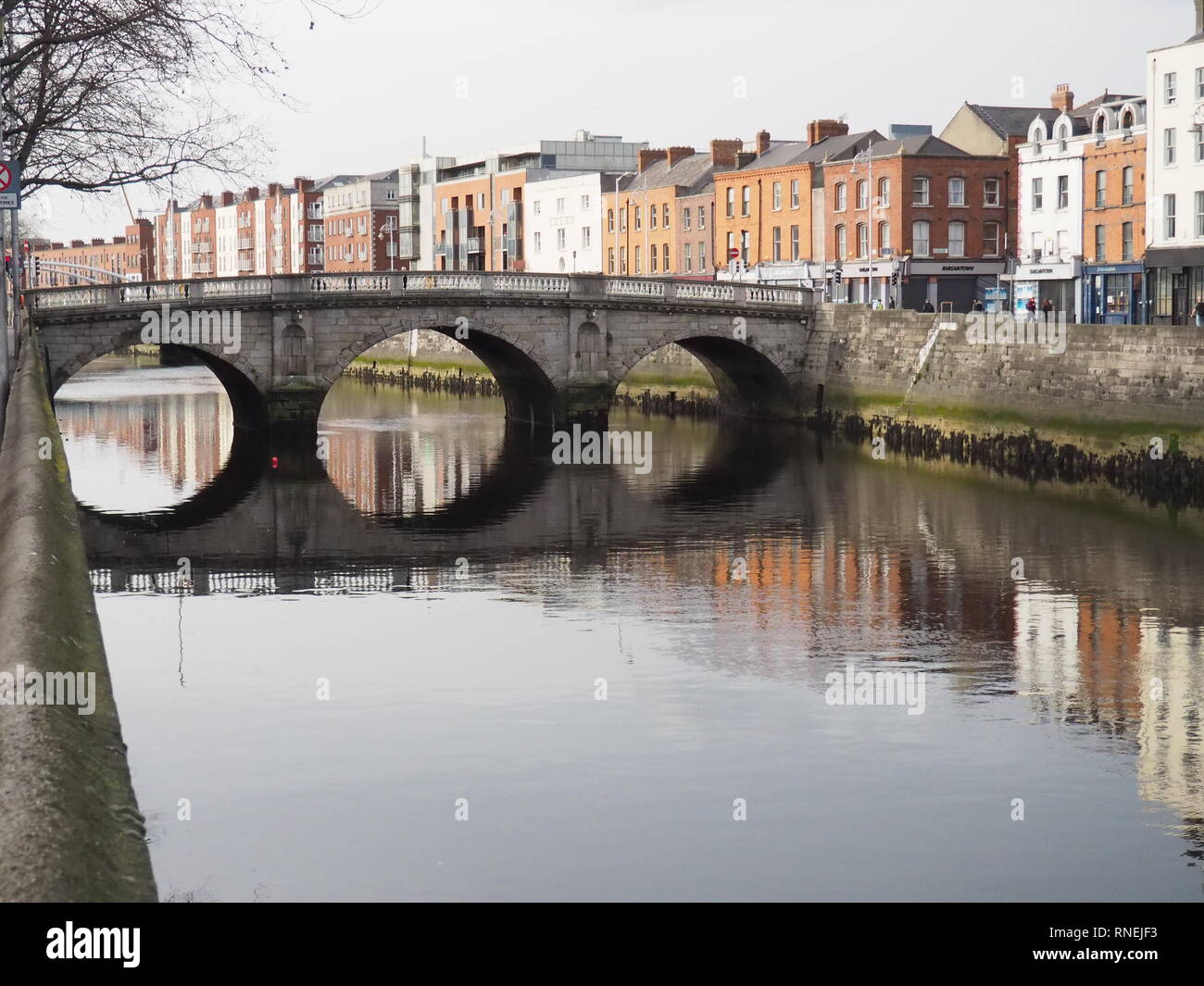 Bridge reflection in the water of River Liffley, Dublin - Ireland Stock Photo