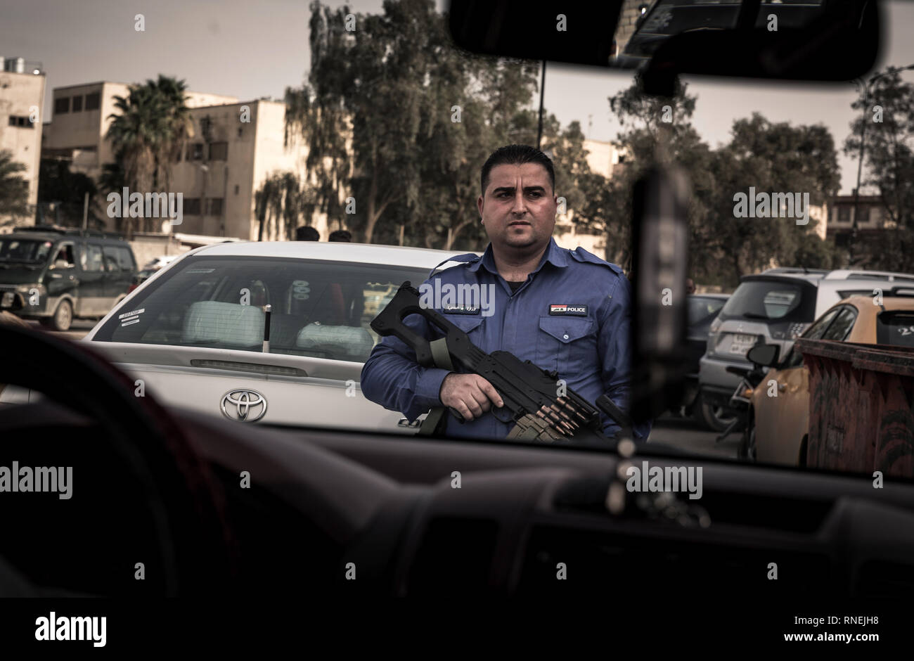 Heavily armed policeman provides security and peace in Mossul. In the city liberated from the IS, numerous armed militias face each other and try to secure their influence. Only the Christian population, who were expelled by the IS, are caught between the fronts. Some churches could be rebuilt, so that church services can take place there again. Nevertheless, the Christians are now threatened and repressed more and more, so that they do not have good perspectives for a further life here. Stock Photo