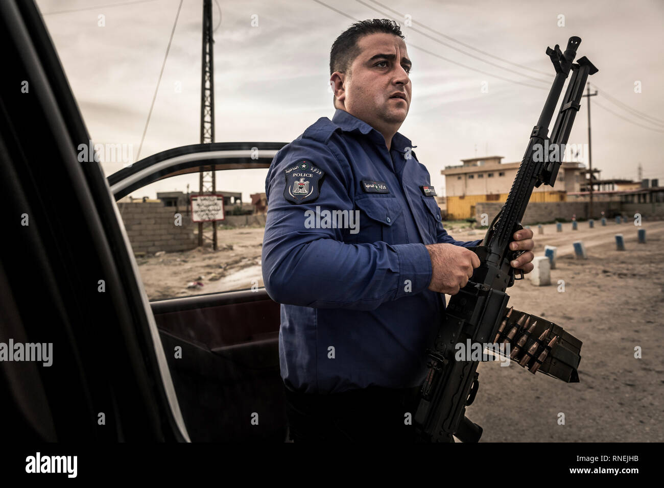 Heavily armed policeman provides security and peace in Mossul. In the city liberated from the IS, numerous armed militias face each other and try to secure their influence. Only the Christian population, who were expelled by the IS, are caught between the fronts. Some churches could be rebuilt, so that church services can take place there again. Nevertheless, the Christians are now threatened and repressed more and more, so that they do not have good perspectives for a further life here. Stock Photo