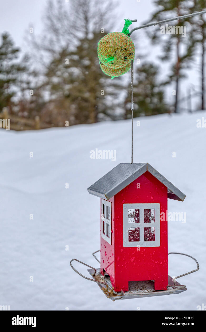Red Outdoor Birdhouse Or Feeding Station For Birds In Winter
