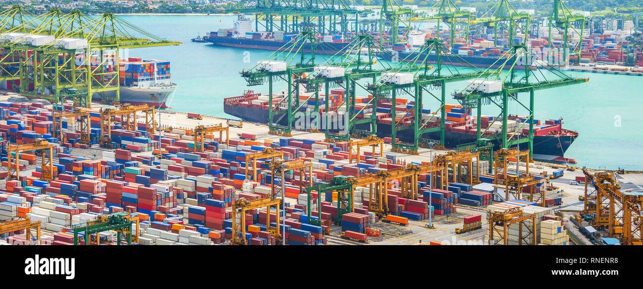 Aerial panorama of cargo ships in Singapore industrial port harbor by pier  with freight cranes and goods containers, seacsape at background Stock  Photo - Alamy
