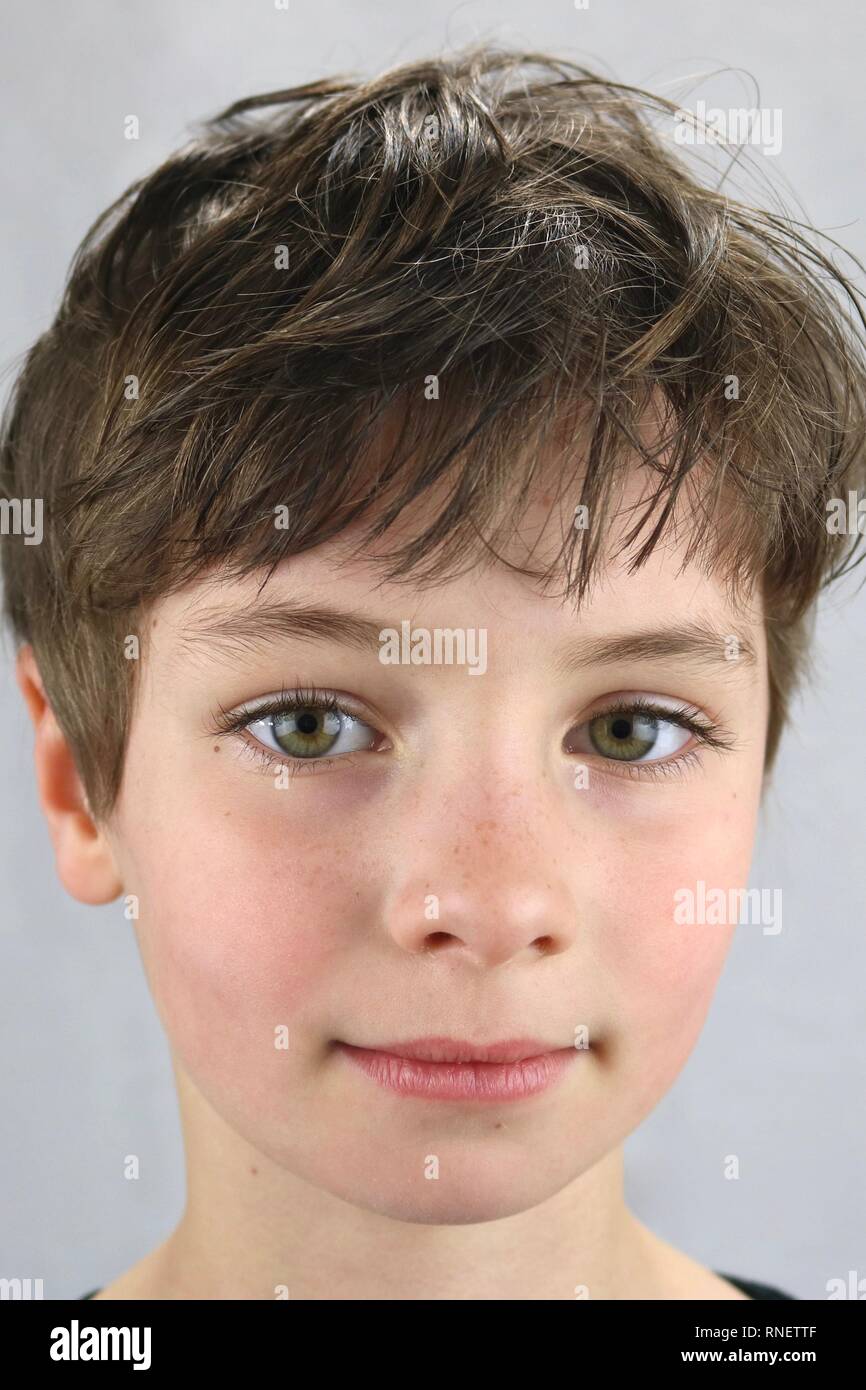 Portrait of a child with big green eyes and a serious look on the face Stock Photo