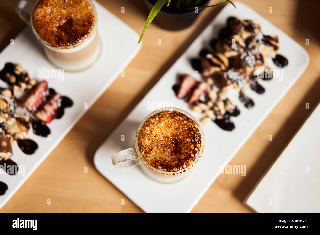 Two Cups Of Hot Latte With Baked Caramel Crust And Sweet Roll With Banana And Strawberry On The Wooden Table In Coffe Shop Coffee Concept Top View P Stock Photo Alamy Two Cups Of Hot Latte With Baked Caramel Crust And Sweet Roll With Banana And Strawberry On The Wooden Table In Coffe Shop Coffee Concept Top View P Stock Photo Alamy