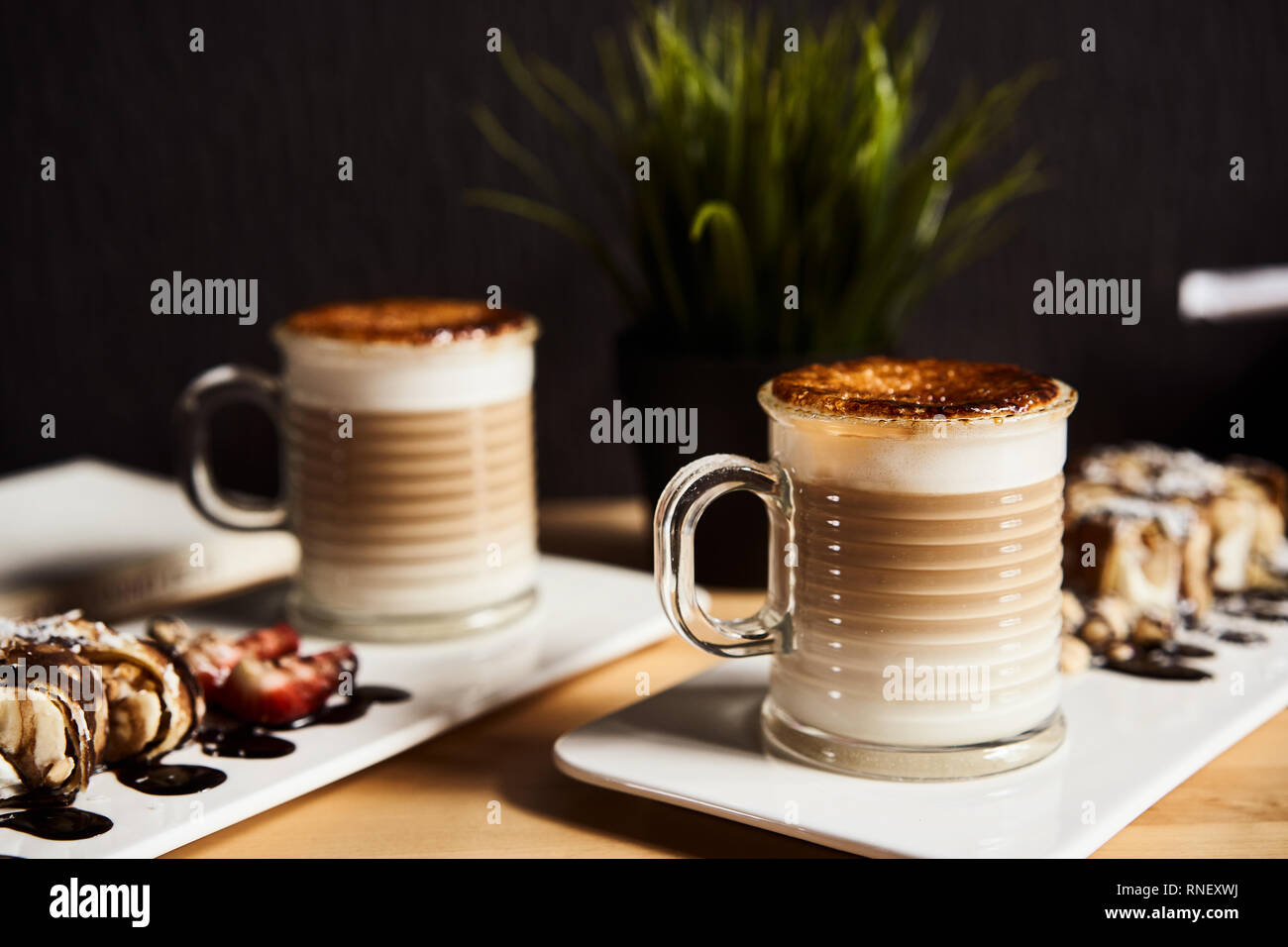 Two Cups Of Hot Latte With Baked Caramel Crust And Sweet Roll With Banana And Strawberry On The Wooden Table In Coffe Shop Coffee Concept Stock Photo Alamy Two Cups Of Hot Latte With Baked Caramel Crust And Sweet Roll With Banana And Strawberry On The Wooden Table In Coffe Shop Coffee Concept Stock Photo Alamy