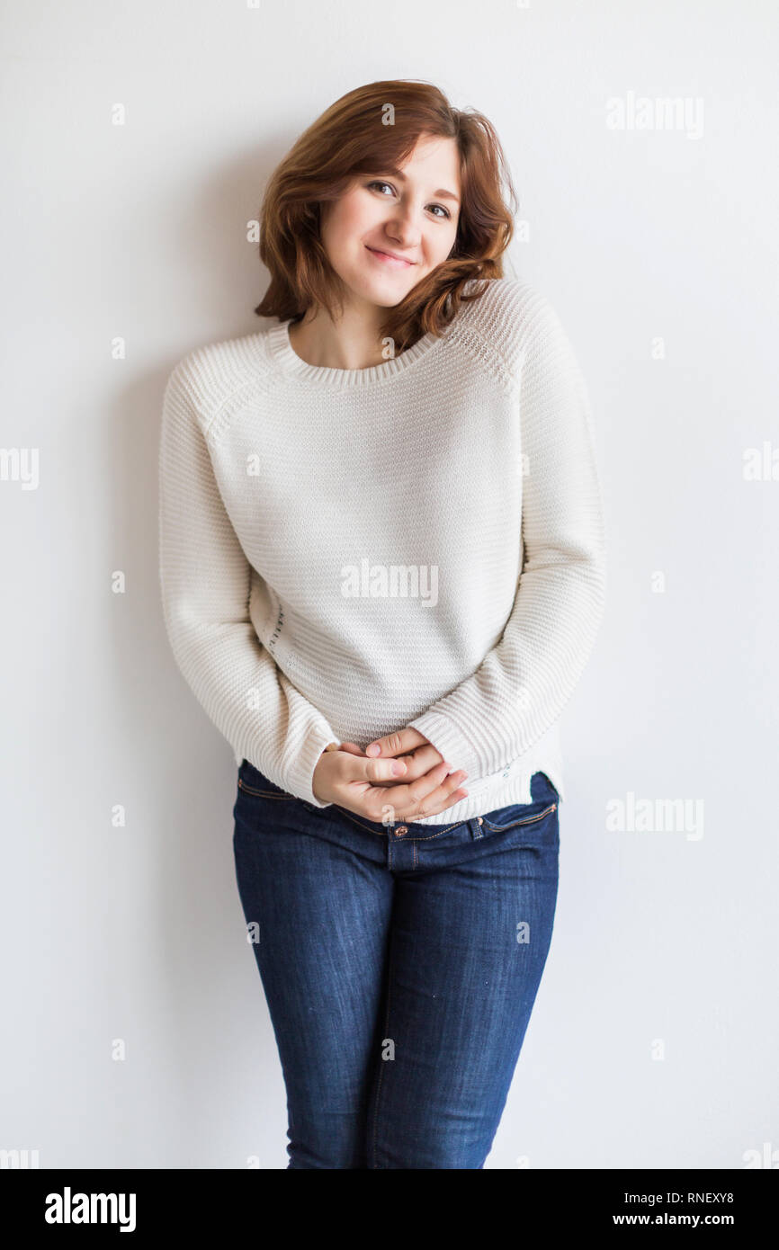 fashion, motherhood, clothing concept. there is stunning young woman who is pregnant almost eight months, she is wearing cosy white sweater that was k Stock Photo