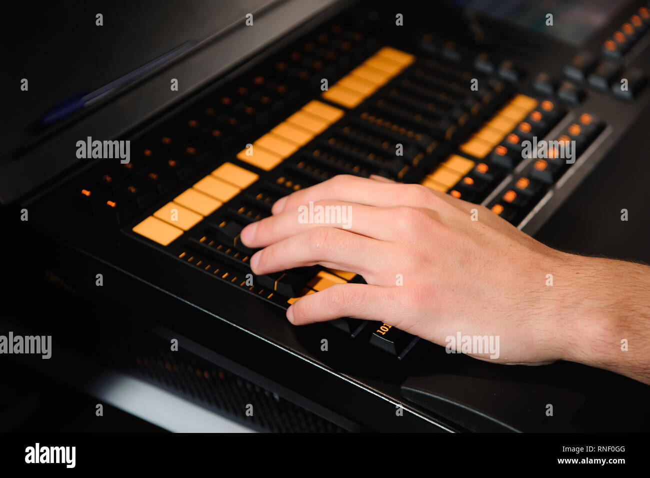 A lighting engineer works with lights technicians control on the ...