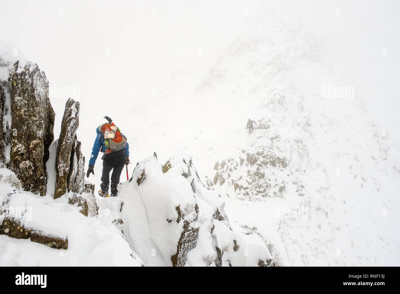 Mountaineer on Striding Edge, Helvellyn, in winter conditions, Lake District National Park, Cumbria, UK. Stock Photo