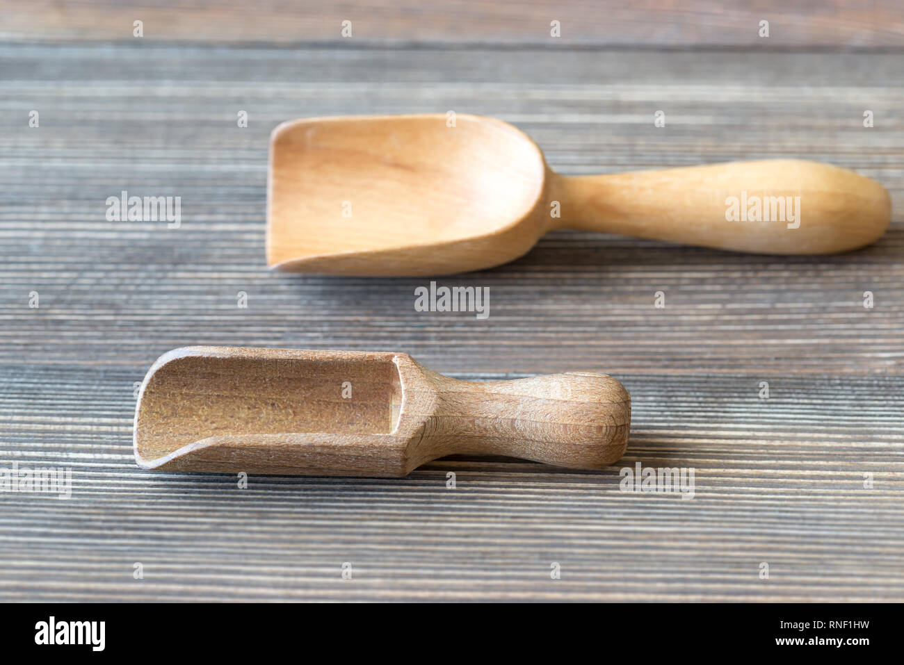 Two empty transfer scoops on the wooden table Stock Photo