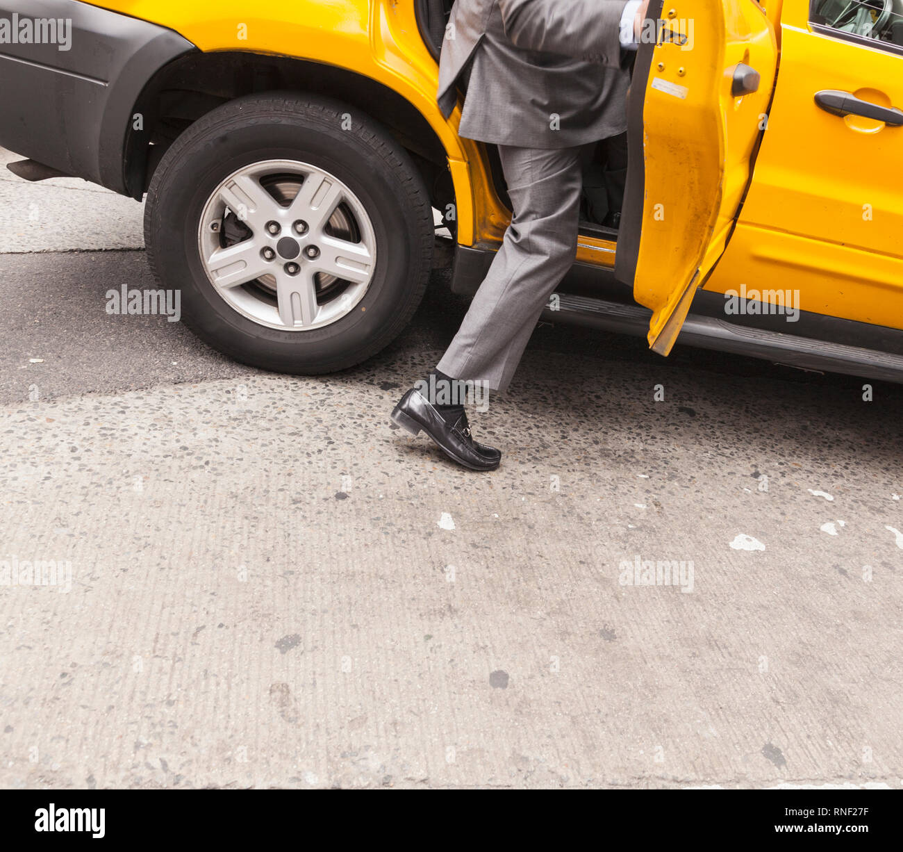 Man enters taxi in Manhattan, New York City, New York, USA. Stock Photo