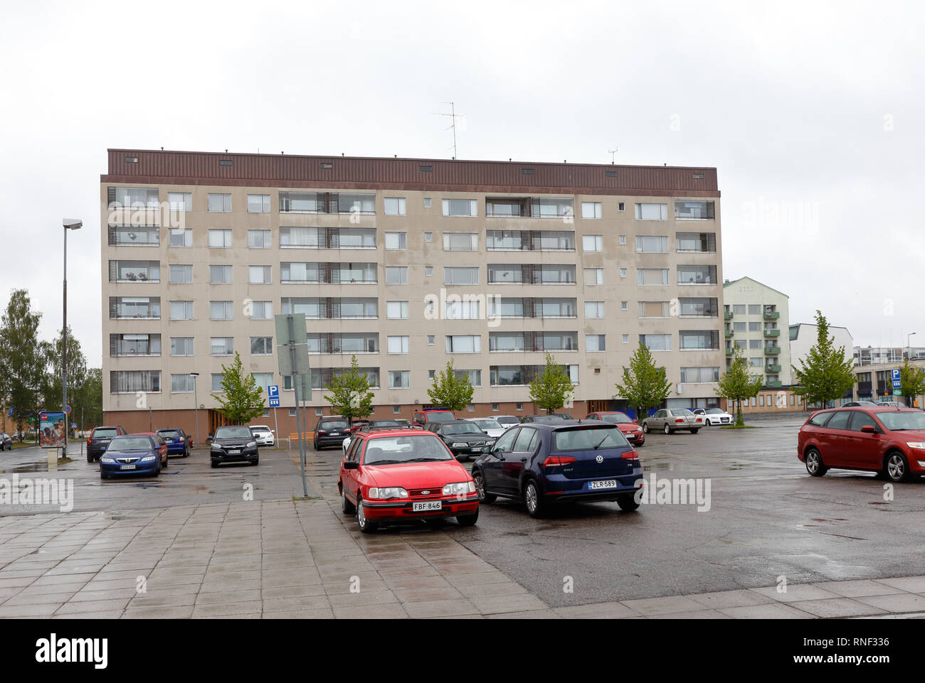 Kemi. Finland - June 19, 2018: Exterial view of a multi-storey multi-family residential building with a parking space in front of it. Stock Photo